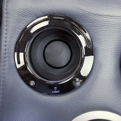 Close-up of a Jude console cup holder with light and cool function markings