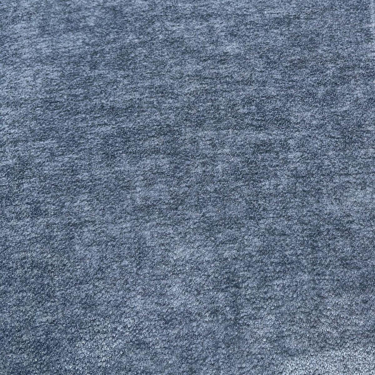 Close-up of the silverish blue fabric used on the Eclipse power recliner sofa