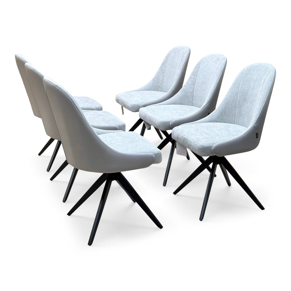 Jose stone grey faux leather swivel dining chairs, set of six with fabric seat pads, angled from the left