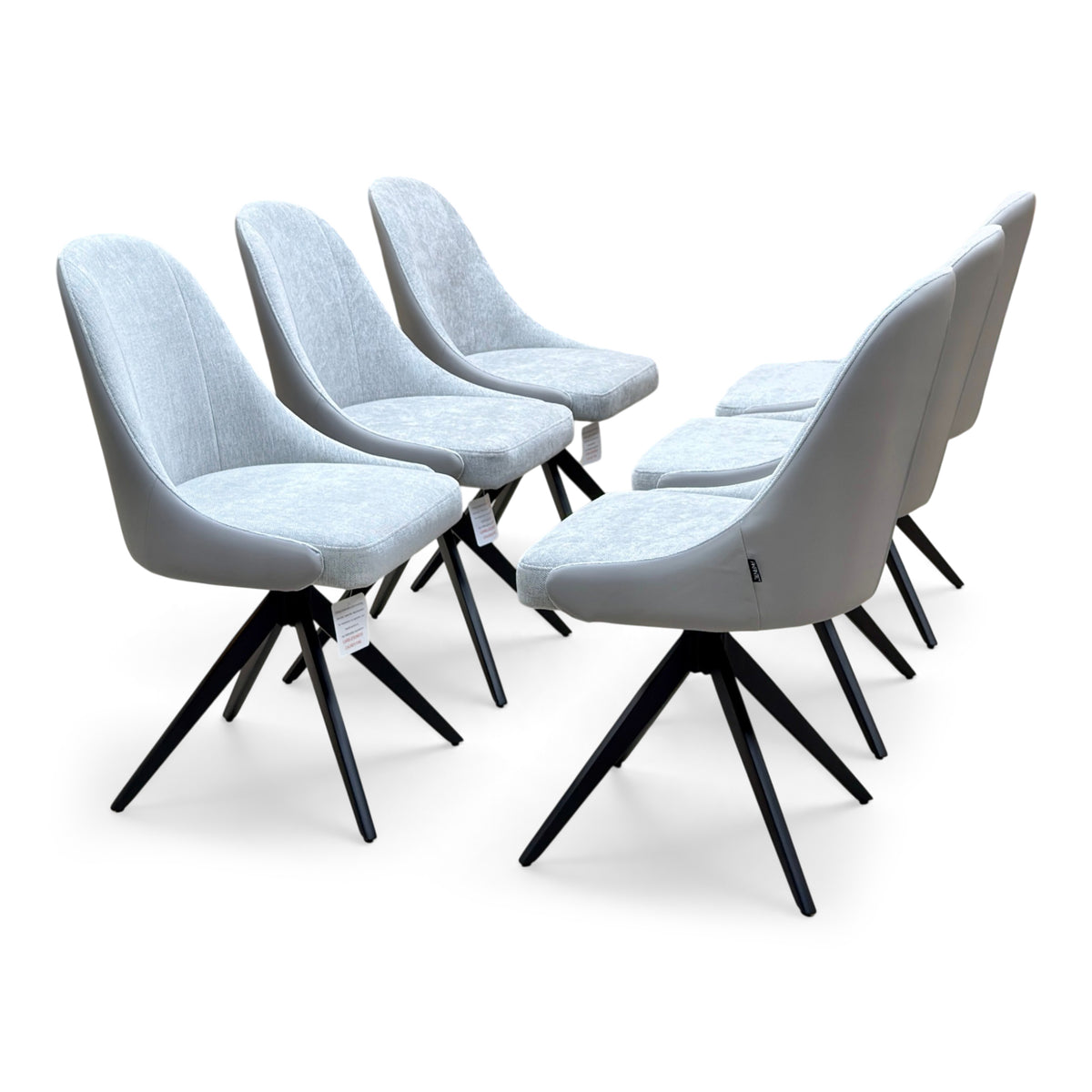Jose stone grey faux leather swivel dining chairs, set of six on black splayed bases, angled from the right