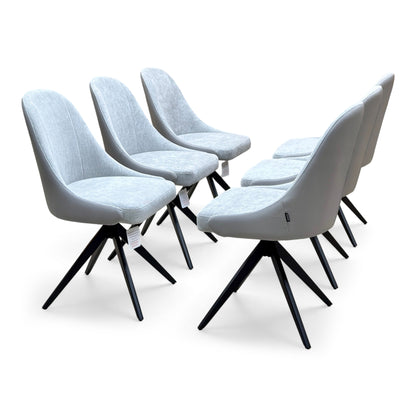 Jose stone grey faux leather swivel dining chairs, set of six on black splayed bases, angled from the right
