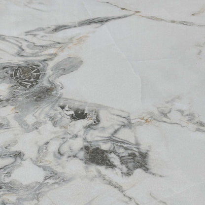 Close-up of the white marble-effect ceramic with grey veining used on the Avorio dining table top