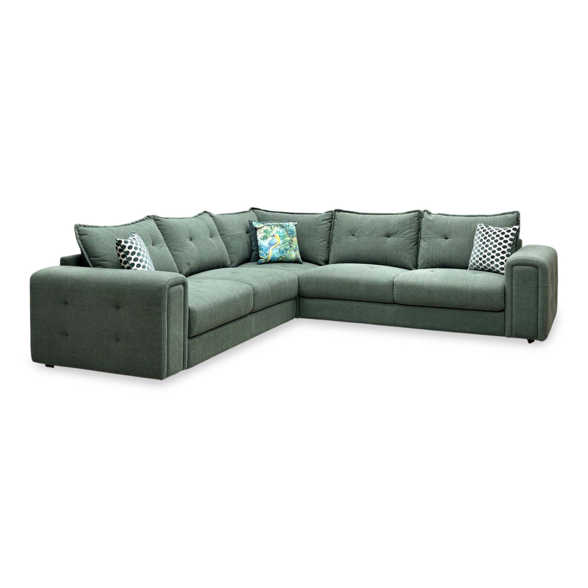 Goliath moss green fabric large corner sofa, angled view from the left showing the buttoned arm panels