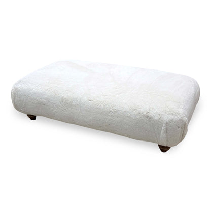 Blenheim Darwin ivory faux fur large footstool, raised angle from the left showing the top