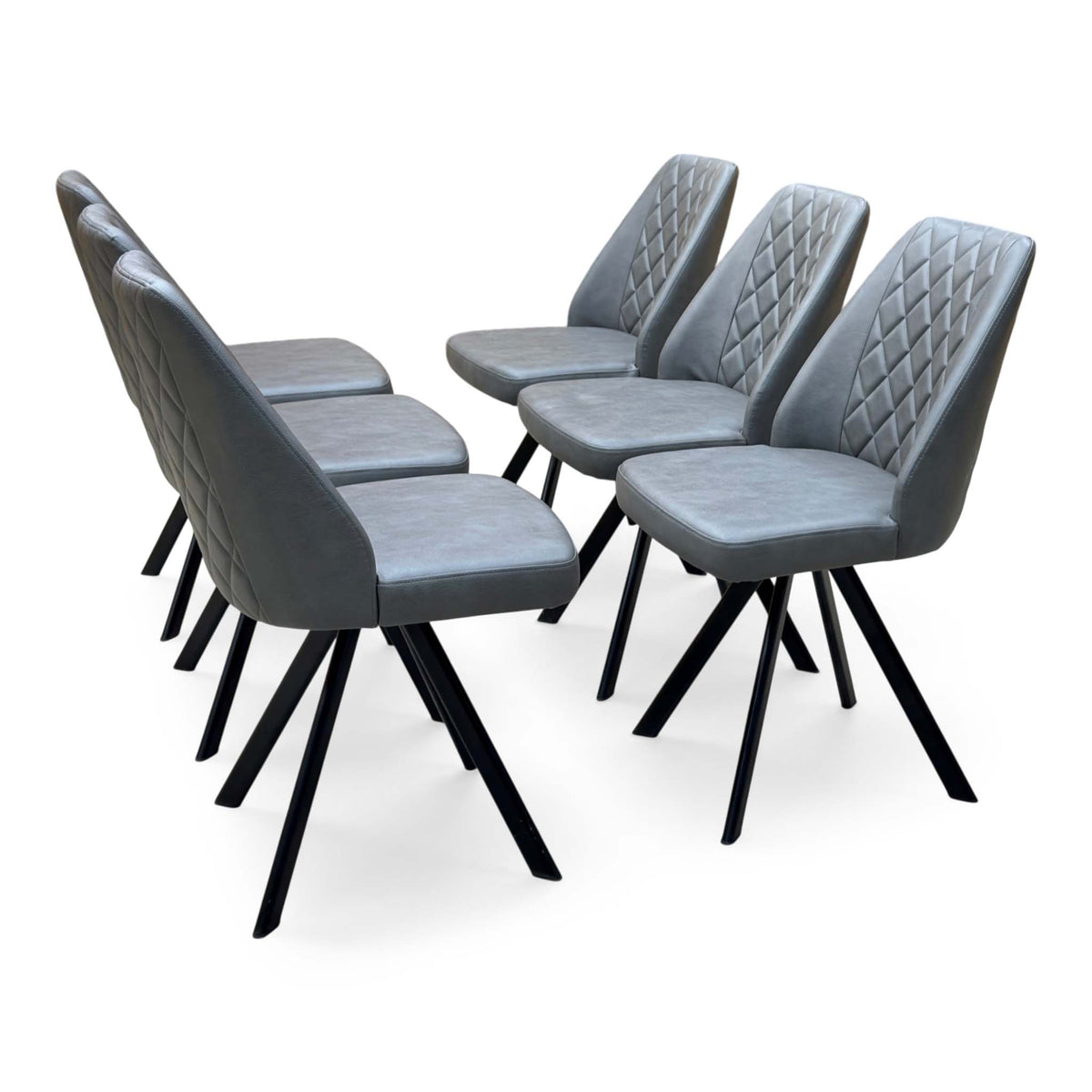 Set of 6 Jupiter grey faux leather swivel dining chairs, angled view with quilted backs and black metal legs