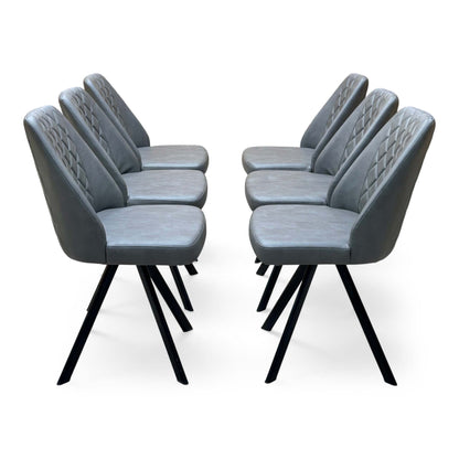 Side view of the set of 6 Jupiter grey faux leather swivel chairs in two facing rows showing the quilted backs