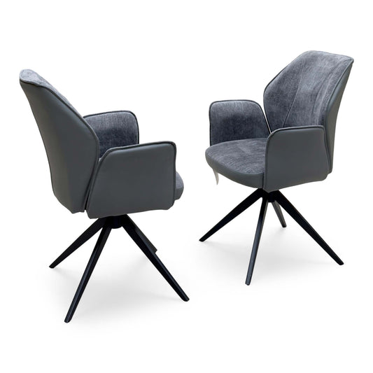 Julio anthracite grey faux leather pair of swivel dining chairs on black star bases, one shown from behind