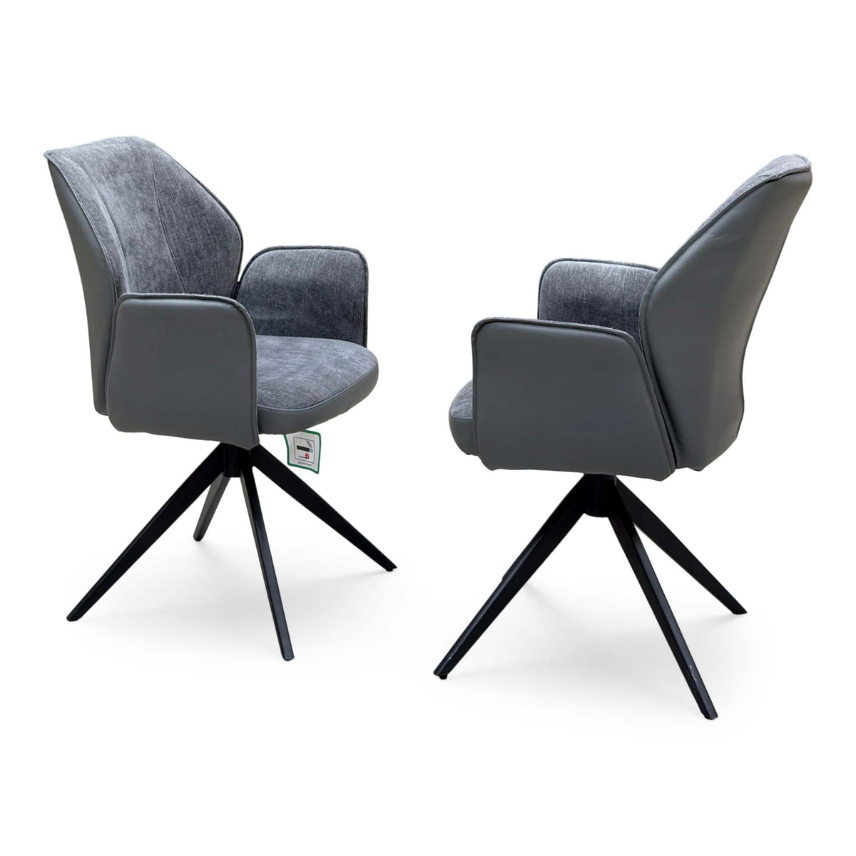 Julio anthracite grey faux leather pair of swivel dining chairs with padded arms, angled front view