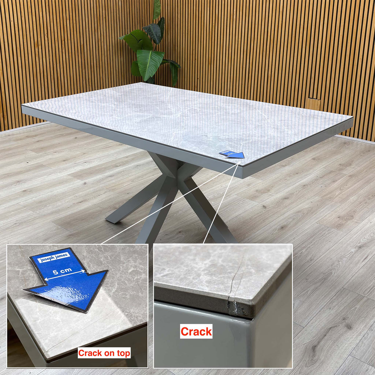 Fumo grey dining table with a crack at one corner of the top, marked with a 5cm arrow and shown in two inset close-ups