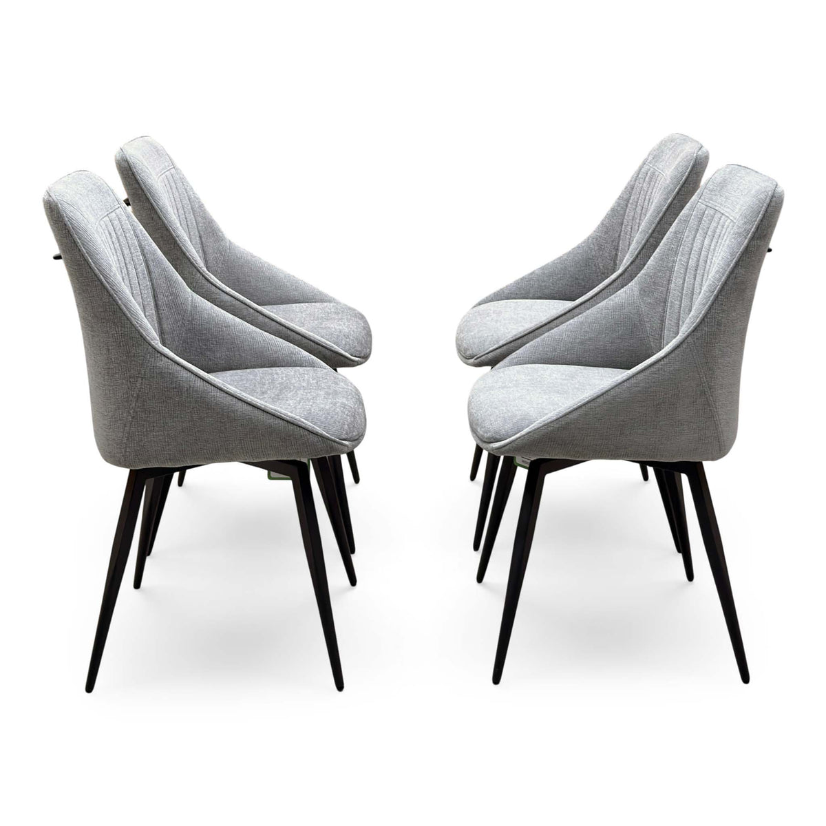 Side view of the Crete light grey fabric set of 4 dining chairs in two facing pairs on black tapered legs