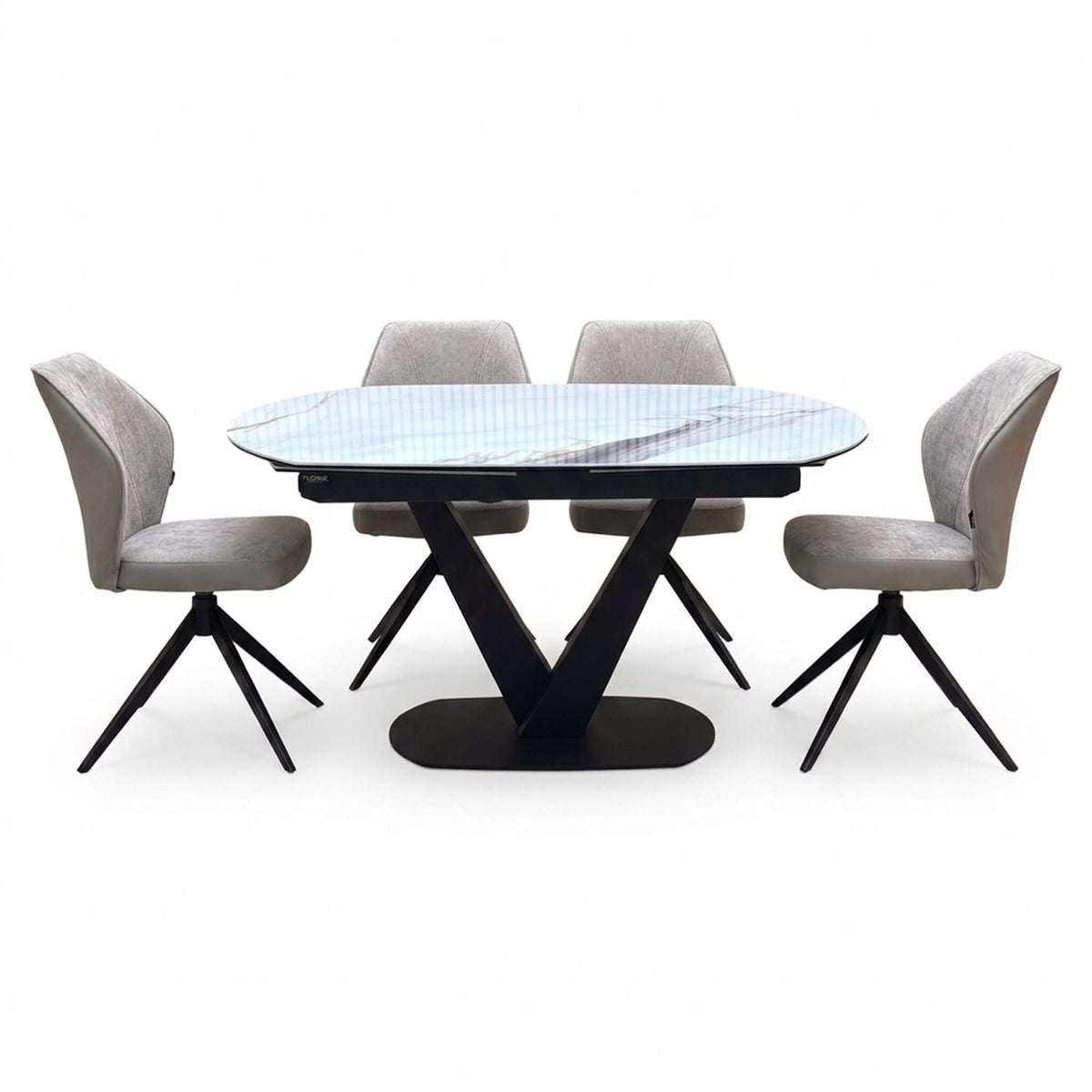 Julio grey-veined marble ceramic dining table with four cream fabric swivel chairs around it, front angle