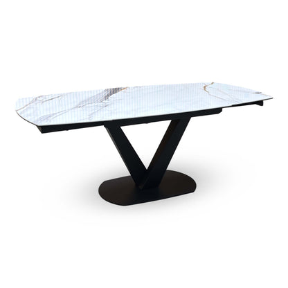 Julio marble ceramic dining table extended to full length with both leaves out, angled view