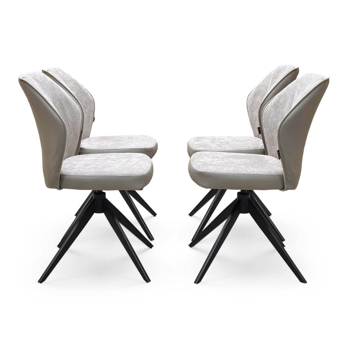 Side view of the four cream fabric swivel chairs from the Julio dining set on black spider legs