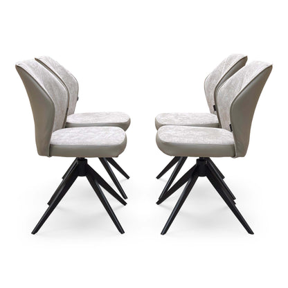 Side view of the four cream fabric swivel chairs from the Julio dining set on black spider legs