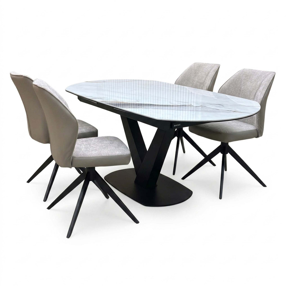 Julio grey-veined marble ceramic 130cm dining table set with four cream swivel chairs, two seen from behind