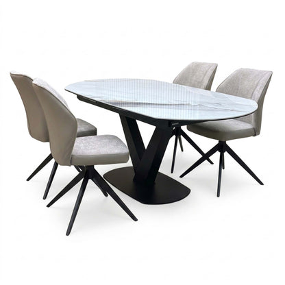 Julio grey-veined marble ceramic 130cm dining table set with four cream swivel chairs, two seen from behind