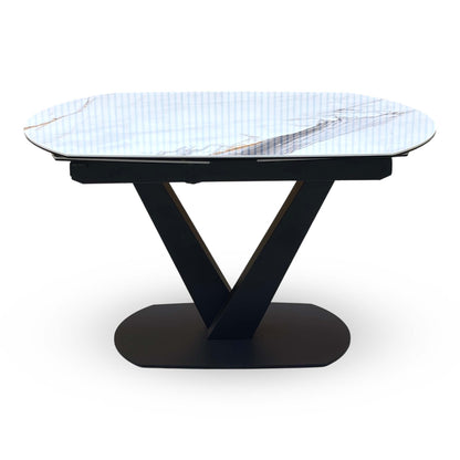 Front view of the Julio marble ceramic extending dining table showing the black V pedestal base