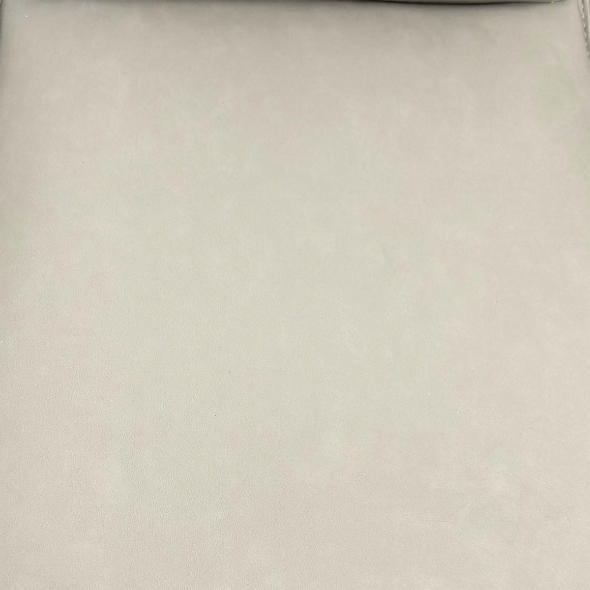 Close-up of the taupe faux leather used on the Catalina swivel dining chairs