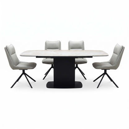 Front view of the Catalina ceramic dining table on its black pedestal base with four taupe faux leather swivel chairs