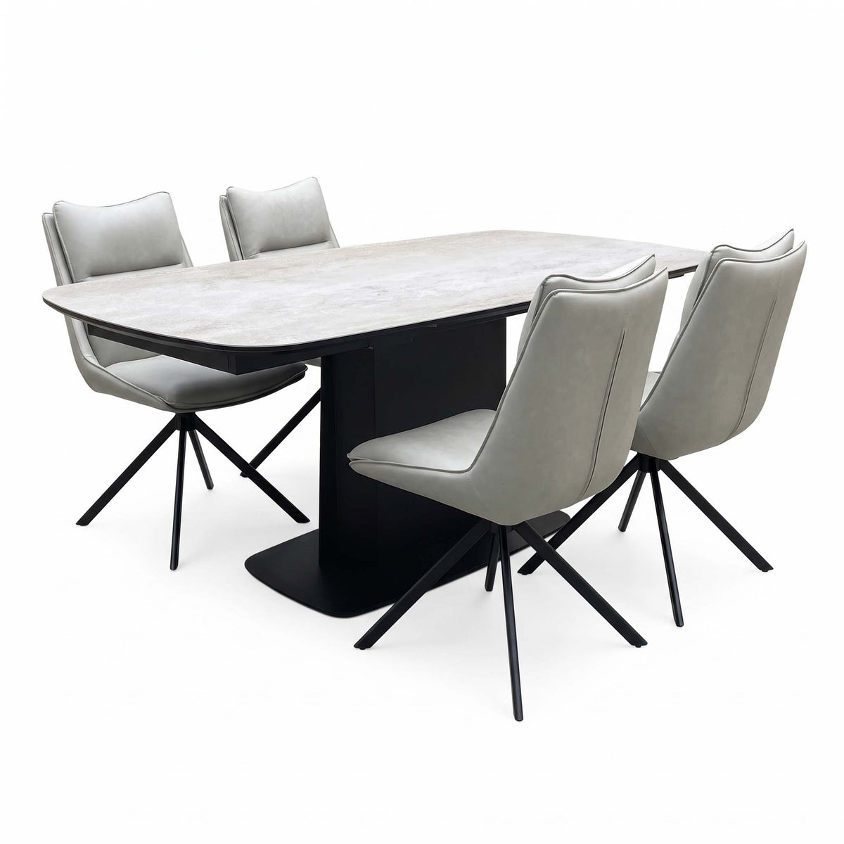 Catalina extending ceramic dining table with four taupe faux leather swivel chairs, angled from the right
