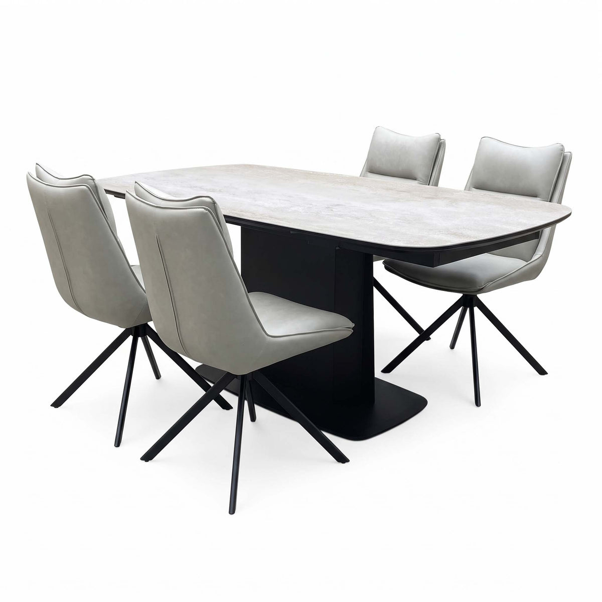 Catalina large extending dining table closed with four taupe swivel chairs, angled view showing the black pedestal base