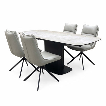 Catalina ceramic top table and taupe faux leather chairs angled from the left, chairs on black four-point swivel legs