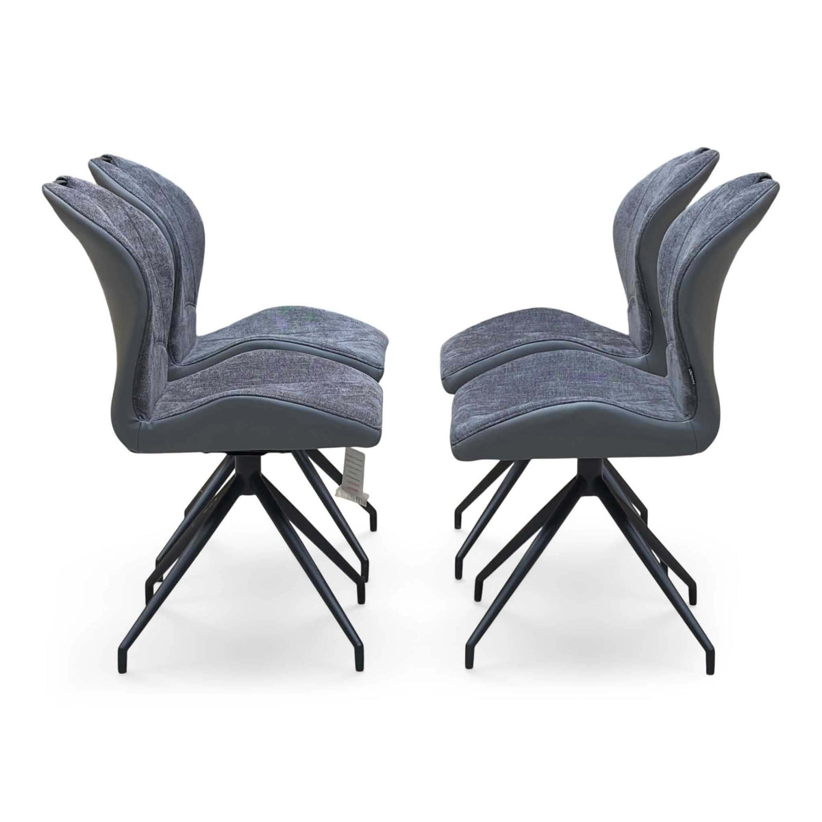 Side view of the 4 grey swivel dining chairs from the Raul set, showing the curved seats and black legs