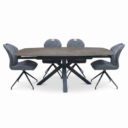 Front view of the Raul titanium grey ceramic dining table extended, with the set of 4 grey swivel chairs