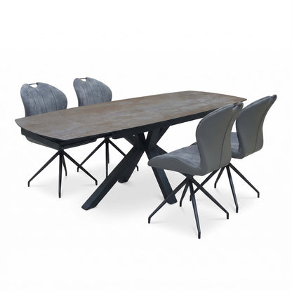 Raul titanium grey ceramic extending dining table and 4 swivel chairs, angled view with the table extended