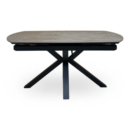 Front view of the Raul titanium grey ceramic 160cm dining table on its own, closed, with crossed black legs