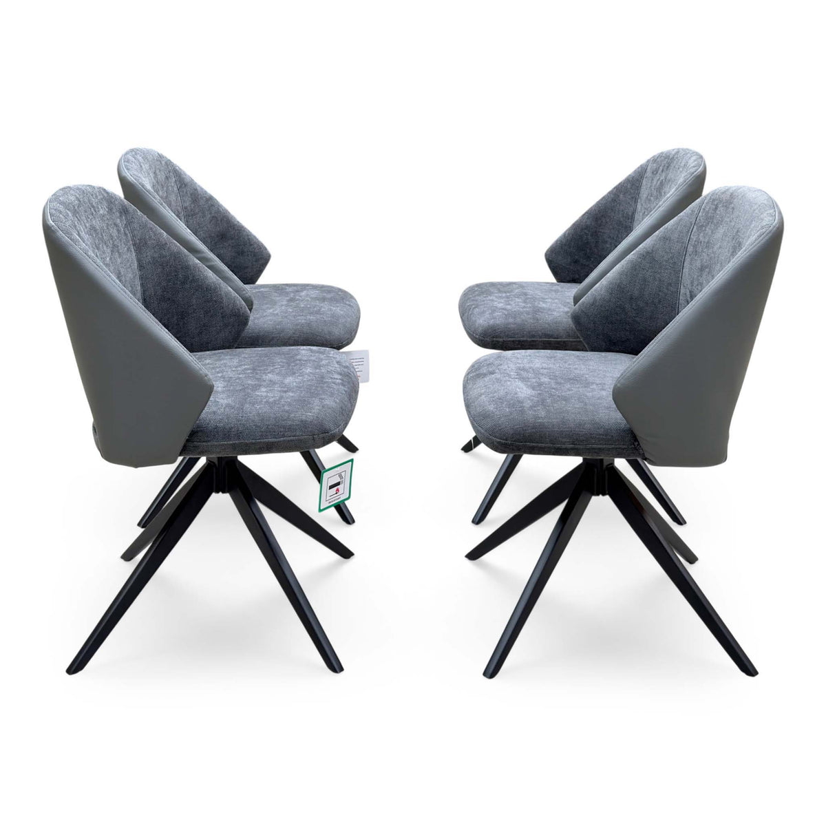 Side view of the 4 Raul grey swivel dining arm chairs from the set, showing black four-star swivel bases