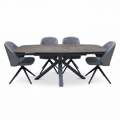 Front view of the Raul grey ceramic dining table extended, with 4 grey faux leather swivel dining chairs