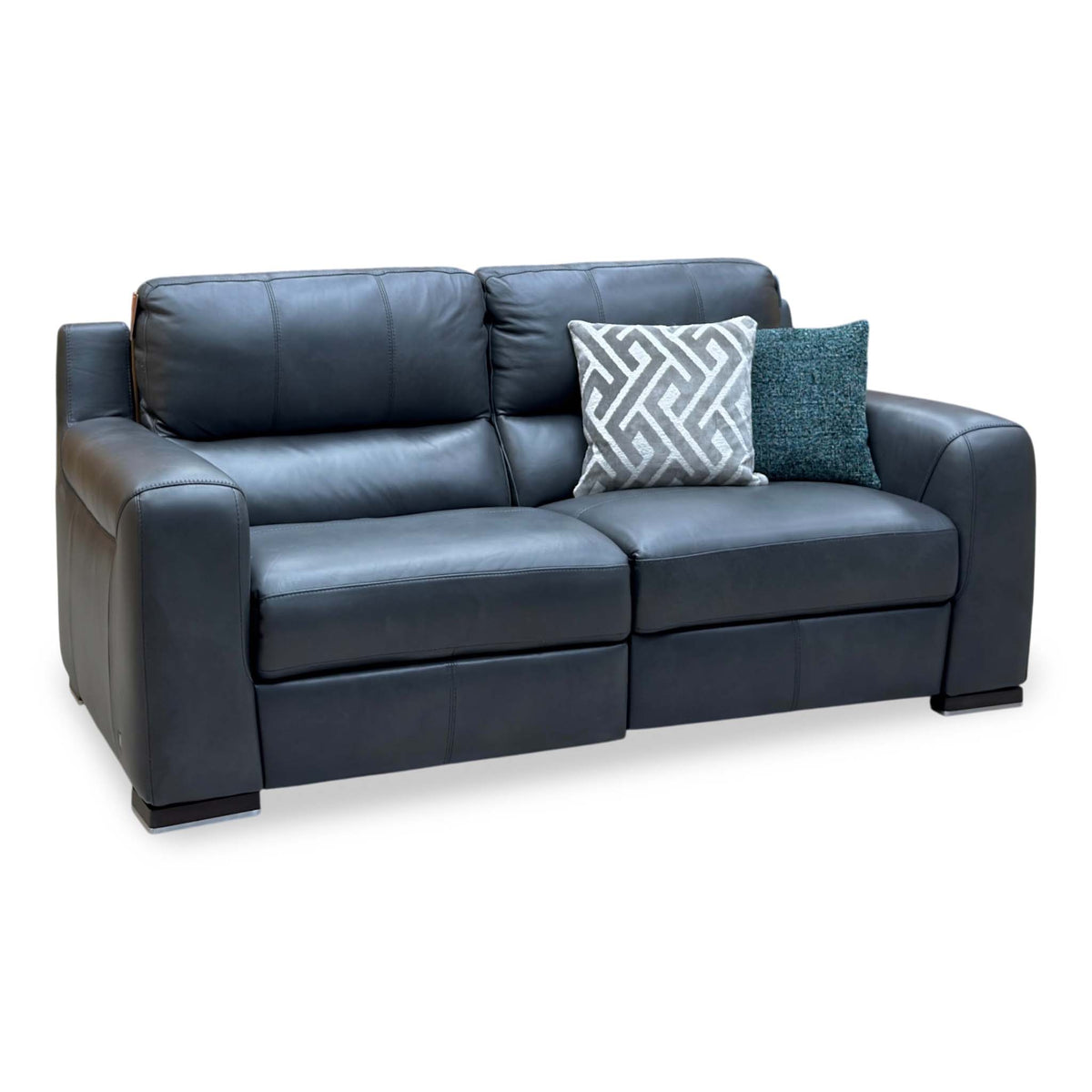 Marinelli Viali grey leather 3 seater power recliner sofa upright, angled view from the left with two scatter cushions