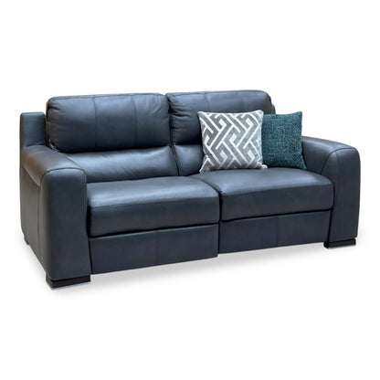 Marinelli Viali grey leather 3 seater power recliner sofa upright, angled view from the left with two scatter cushions