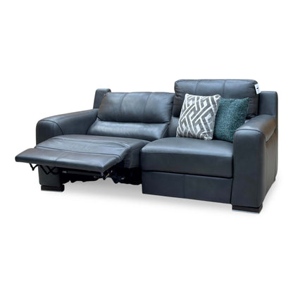 Viali grey leather power recliner sofa seen from the left with the footrest raised in the reclined position