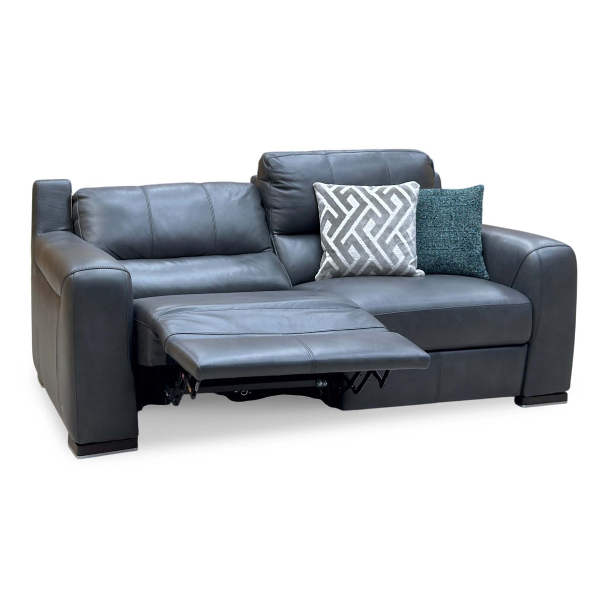 Marinelli Viali grey leather 3 seater power recliner sofa with the left seat reclined, angled view with cushions