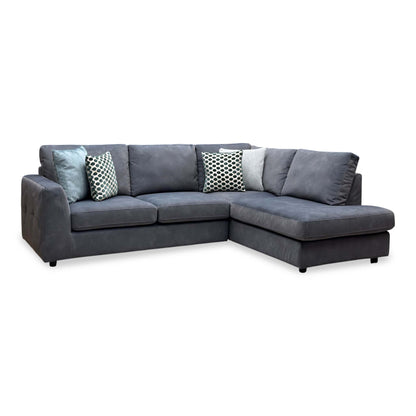 Dinky shadow grey velvet right hand facing corner chaise end sofa, angled view with patterned scatter cushions