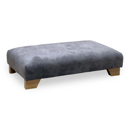 Aura mink velvet designer footstool with oak block feet, angled view
