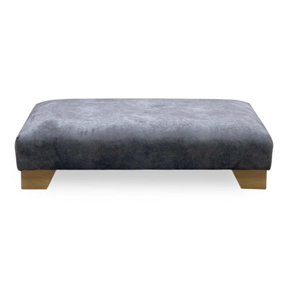 Front view of the Aura mink velvet designer footstool on oak block feet