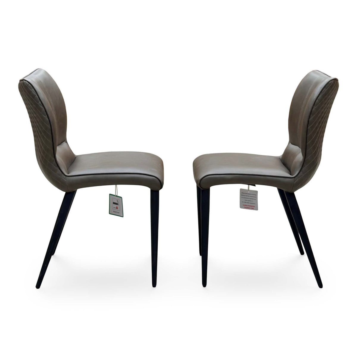 Side angle of the Murcia antiqued olive green dining chairs showing the curved backs and tapered legs