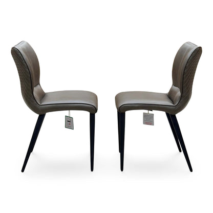 Side angle of the Murcia antiqued olive green dining chairs showing the curved backs and tapered legs