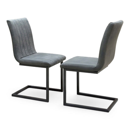 Pair of Moon grey fabric cantilever dining chairs, angled view showing the stitched channel backs and black frames