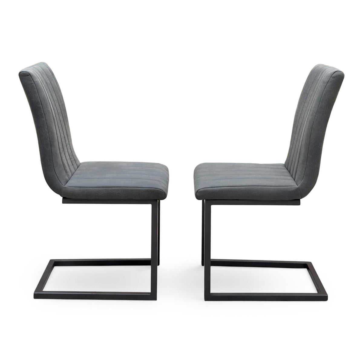 Side view of the pair of Moon grey fabric cantilever dining chairs facing each other