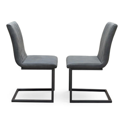 Side view of the pair of Moon grey fabric cantilever dining chairs facing each other