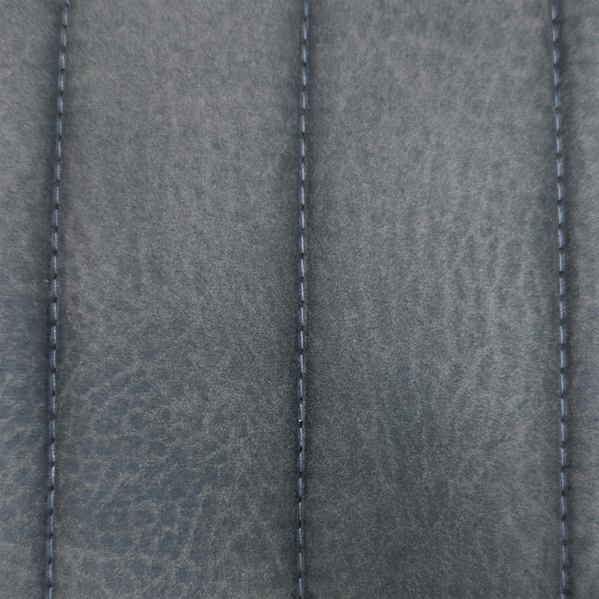 Close-up of the grey stitched channel fabric used on the Moon cantilever dining chairs