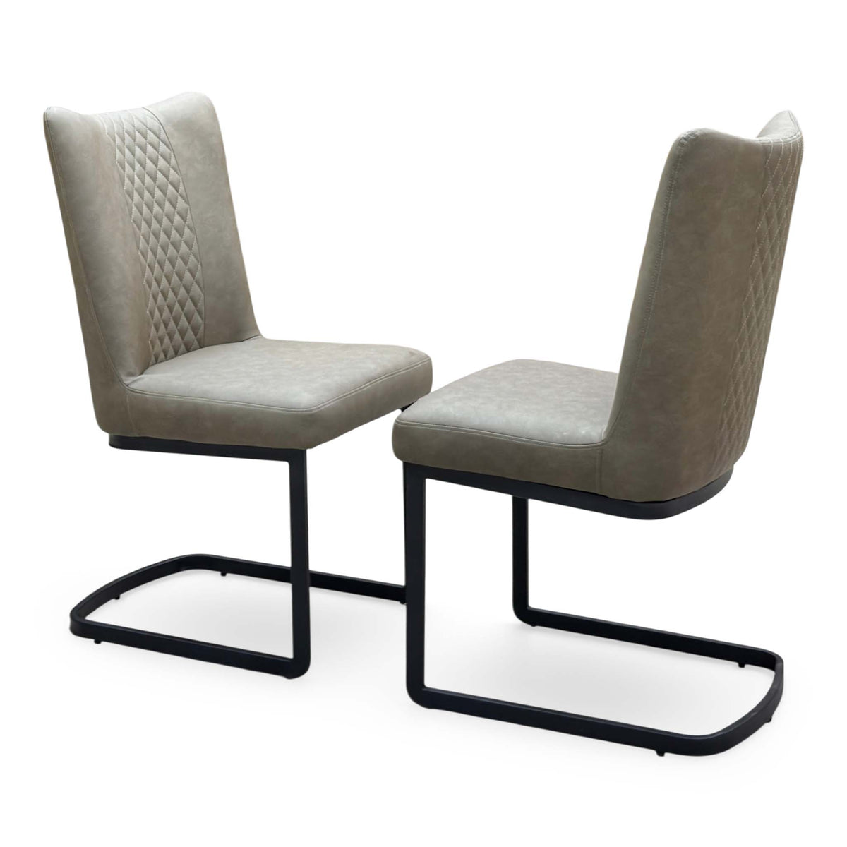 Bodahl Loki olive green fabric pair of cantilever dining chairs angled to show the quilted back panel and padded seat