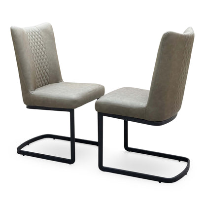 Bodahl Loki olive green fabric pair of cantilever dining chairs angled to show the quilted back panel and padded seat