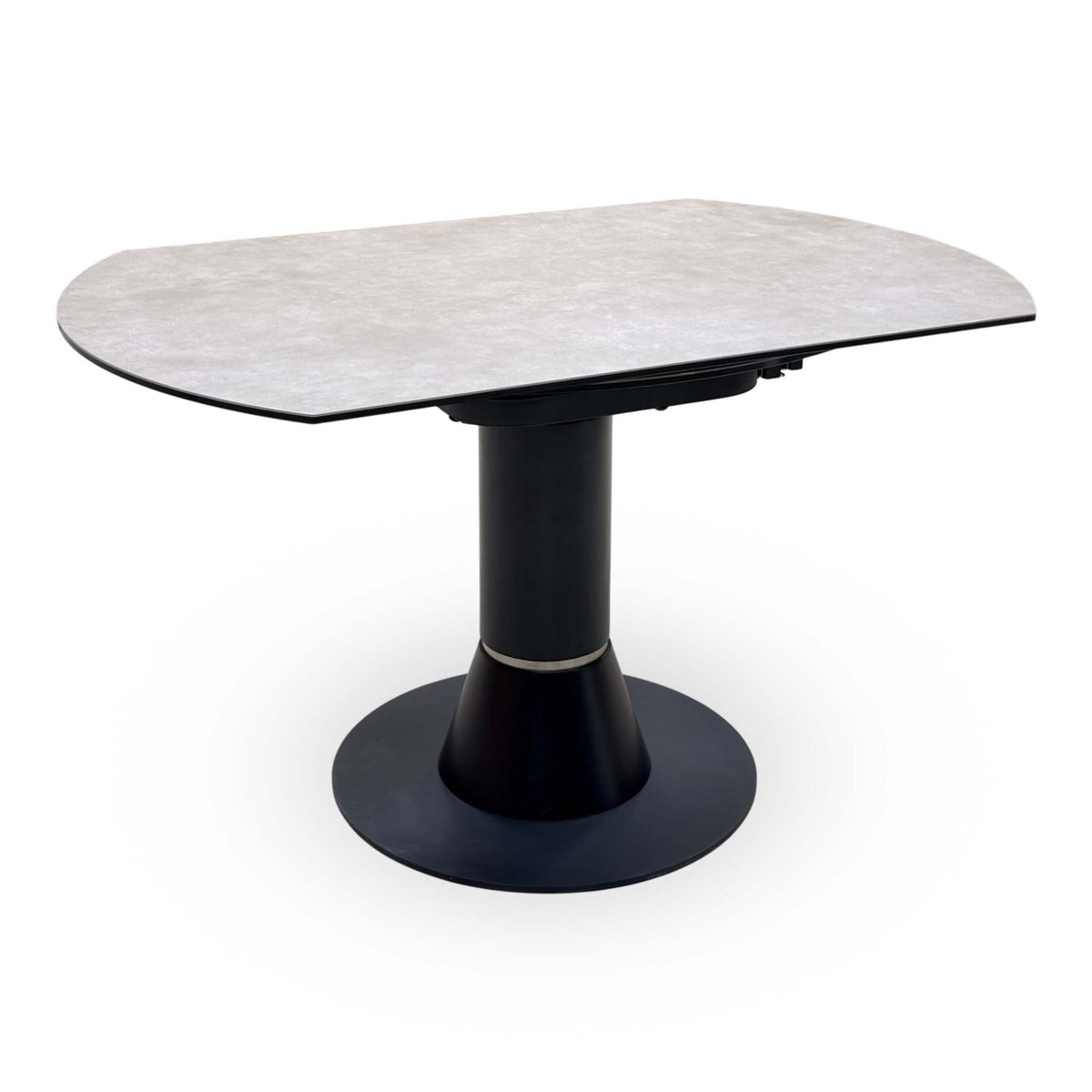 Enterprise grey ceramic top swivel dining table closed to its oval shape, angled view of the black pedestal base