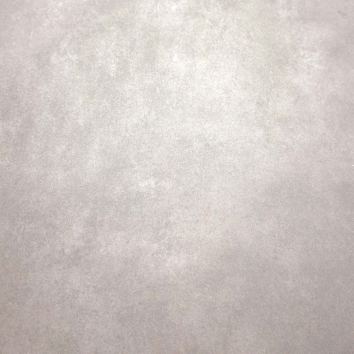 Close-up of the grey stone-effect ceramic top on the Enterprise dining table
