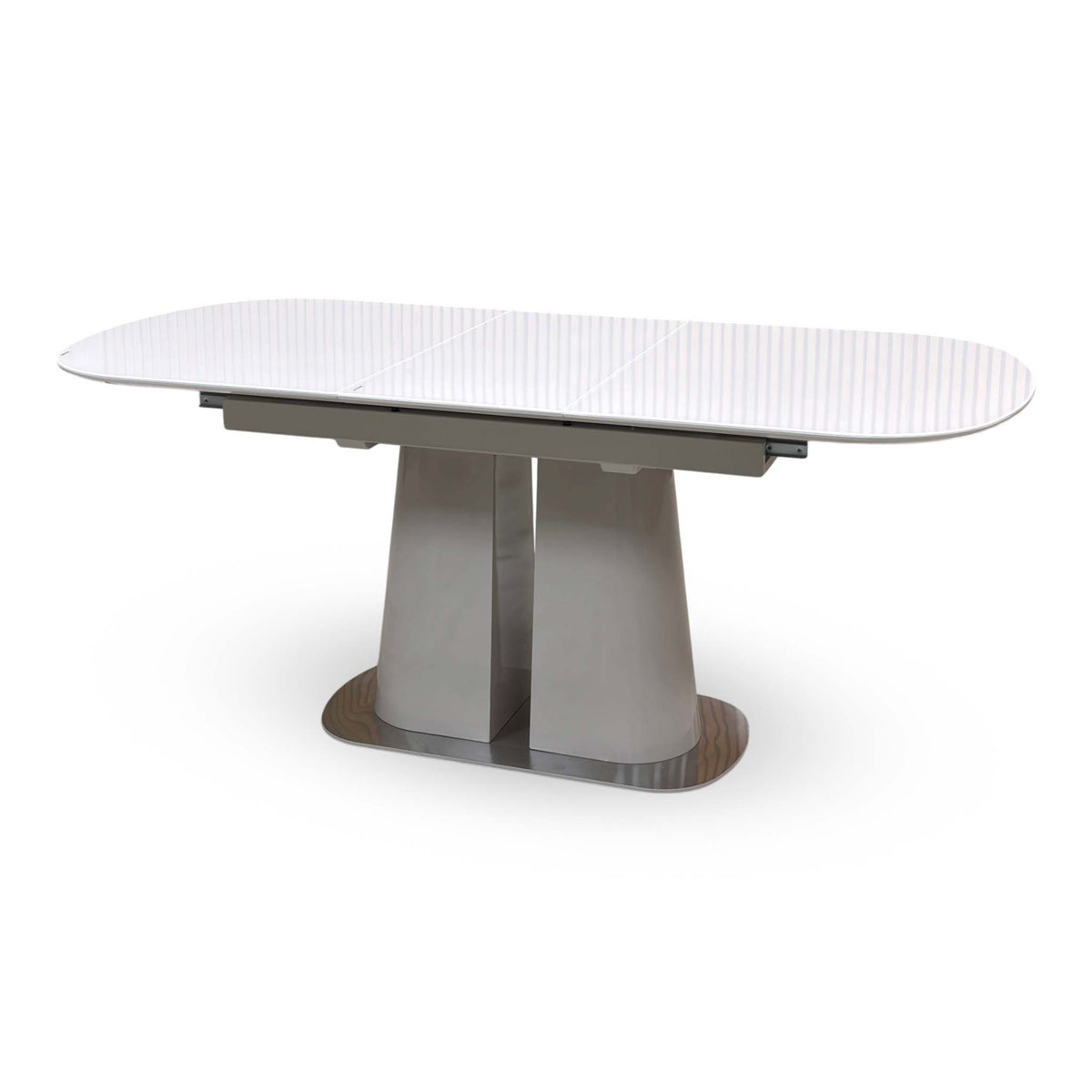 Cashmere white glass top small dining table extended, angled from the right showing the twin pedestal